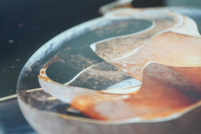 Minimalist abstract metal wall art showing translucent fluid shapes in a glass-like form