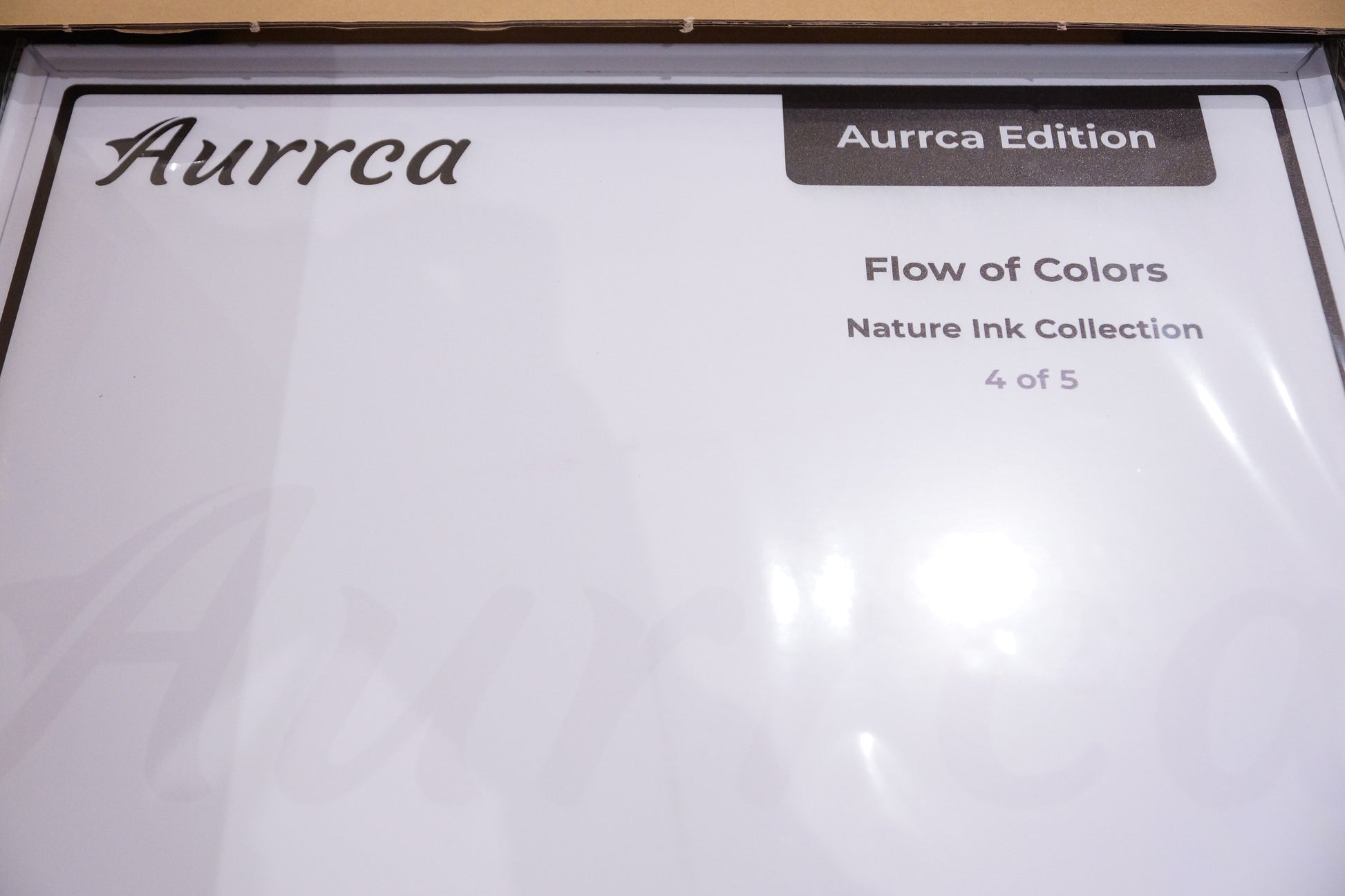 Aurrca metal poster protective sleeve with clean white design and branding detail