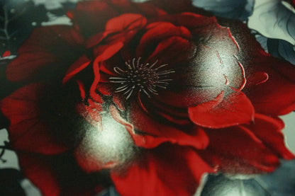 Close-up of vibrant red flower metal wall art with deep contrast and detail